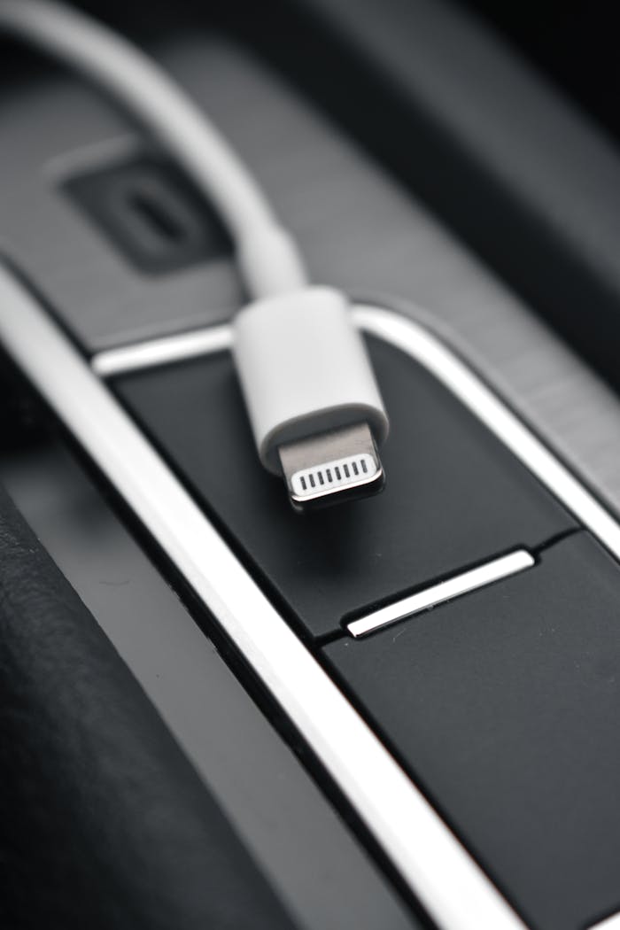 journey A detailed close-up image of a lightning connector against a sleek black surface, ideal for tech themes.